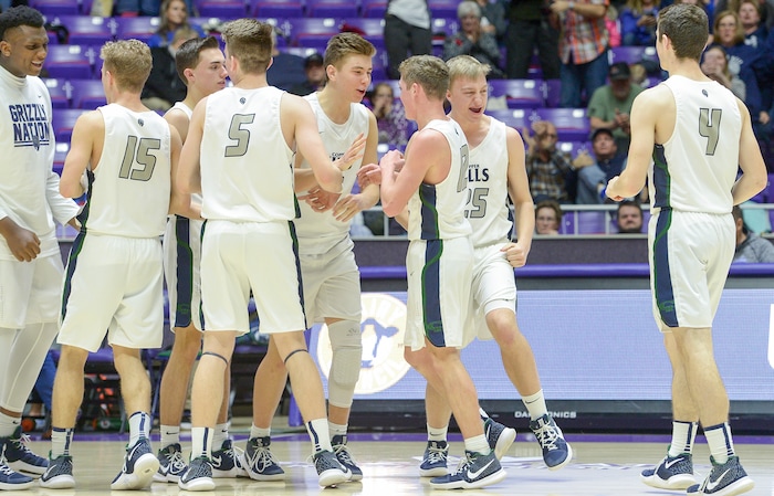 (Leah Hogsten  |  The Salt Lake Tribune) Copper Hills' Bryan Holgate (25) celebrates the win with teammates.Copper Hills defeated Bingham 61-54 in the 6A High School Boys' Basketball Tournament opening game at Weber State University’s Dee Events Center in Ogden, Tuesday, Feb. 27, 2018. 