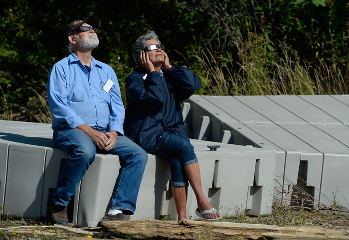(Francisco Kjolseth  |  The Salt Lake Tribune)  Calamity campground hosts Mike and Cheryl Kennedy sit on the spare floating docks at Palisades Reservoir, Idaho, to take in the total eclipse of the sun on Monday, August 21, 2017.