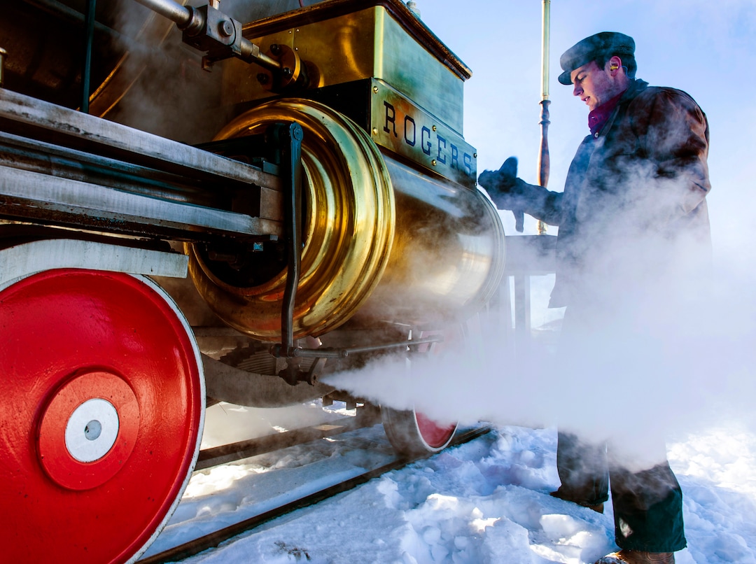 (Rick Egan | The Salt Lake Tribune) Volunteer fireman, Jace Evans, polishes the 119 Steam Engine between runs, at the Golden Spike National Historical Park, on Tuesday, Dec. 29, 2020.