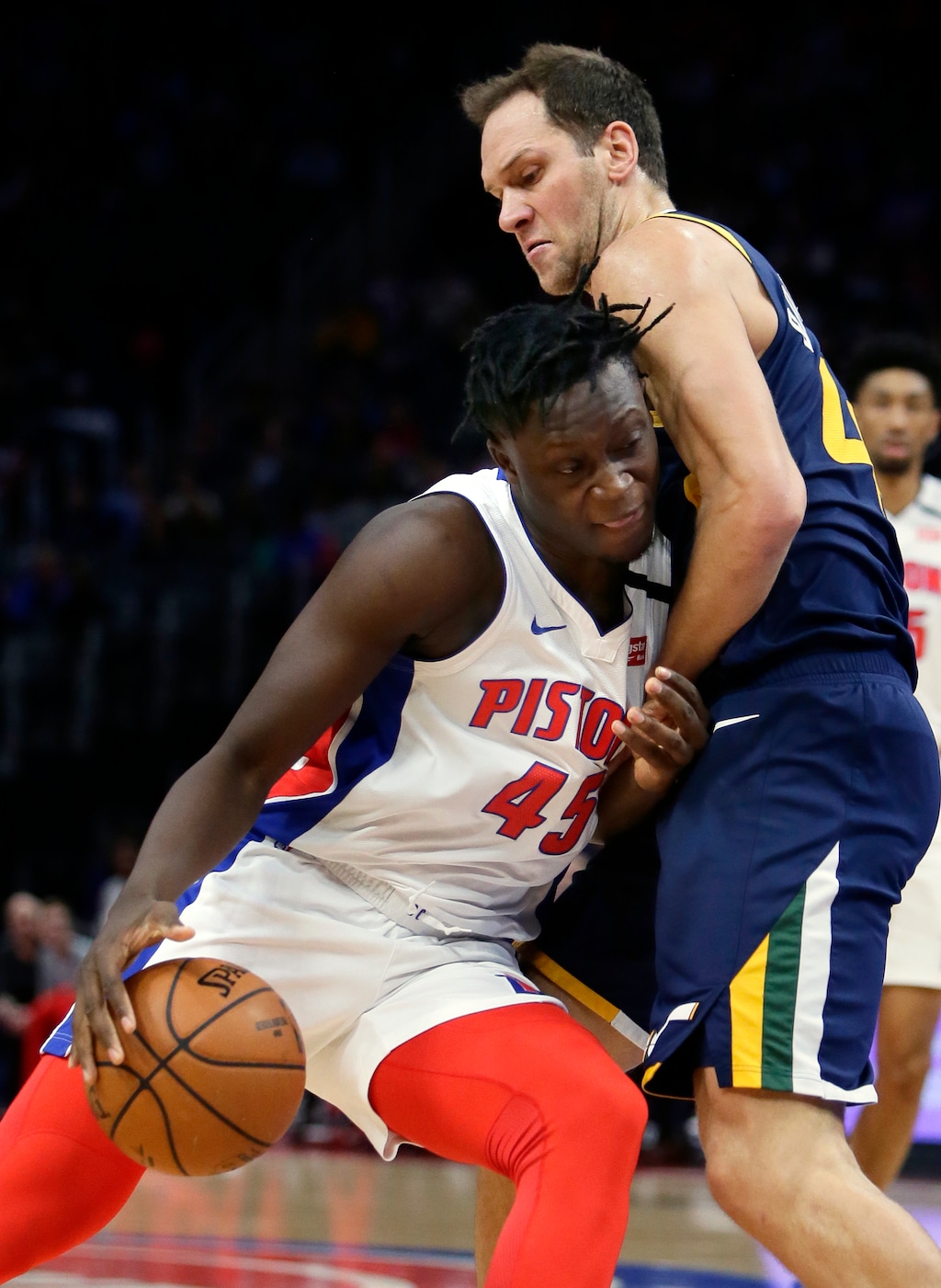 Detroit Pistons forward Sekou Doumbouya (45) collides with Utah Jazz forward Bojan Bogdanovic (44) while driving to the basket during the first half of an NBA basketball game Saturday, March 7, 2020, in Detroit. (AP Photo/Duane Burleson)