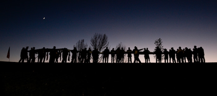 Leah Hogsten  |  The Salt Lake Tribune   Armed Forces veterans fold a gigantic American Flag during the ceremony. Veterans, family members of active and retired military and patriotic supporters celebrated Veteran's Day at the Barker Park amphitheater in North Ogden with a  memorial for North Ogden's hometown hero Army Major Brent Russell Taylor, who was killed in action on November 3, 2018, while training an Afghan Army commando battalion in Afghanistan.
