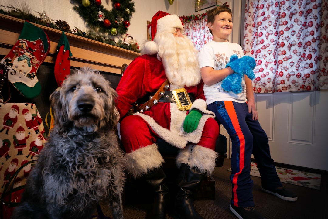 (Trent Nelson  |  The Salt Lake Tribune) Labradoodle Willow and Gavyn MacDonald sit for a photograph with Santa at the Sugar House Santa Shack in Salt Lake City on Friday, Dec. 20, 2019.