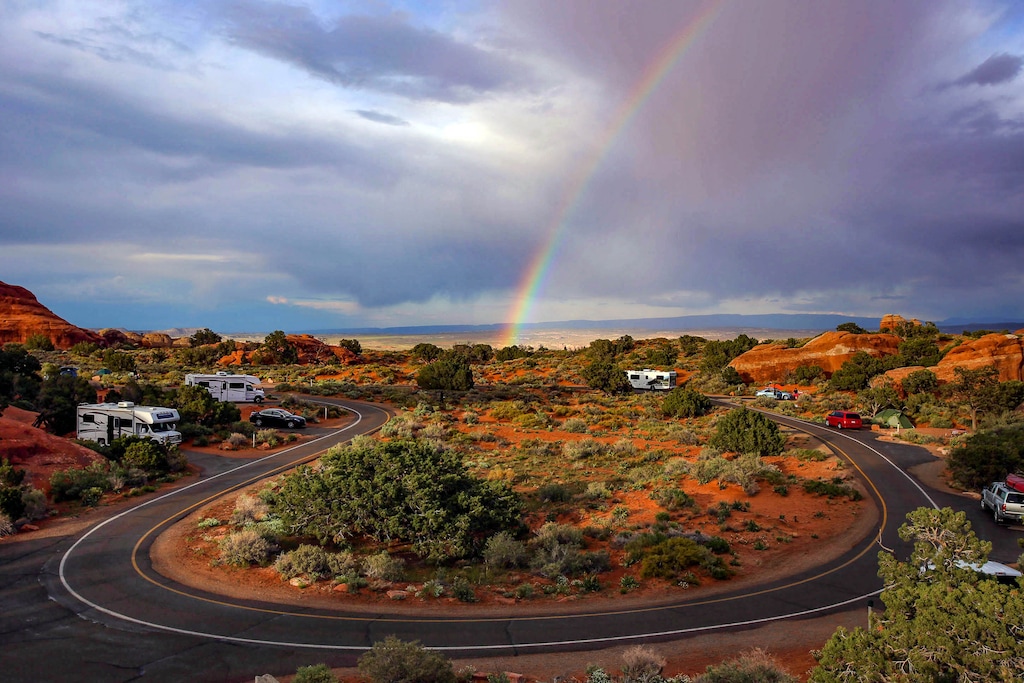 (Francisco Kjolseth  |  The Salt Lake Tribune) The late afternoon sun ignites a rainbow during a brief rain shower in the Devils Garden campground at Arches National Park May 19, 2013. A woman's body was found in this area over the weekend, authorities say.