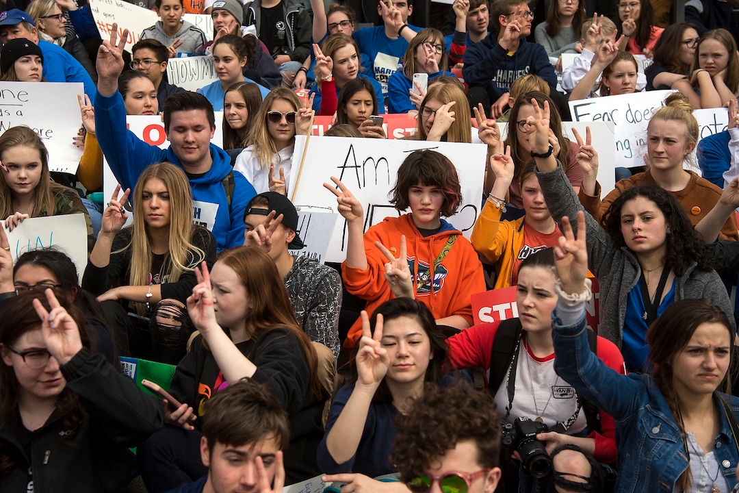 (Chris Detrick  |  The Salt Lake Tribune)  Participants hold up the peace sign as they listen to John Lennon's song 'Imagine' during the March for Our Lives SLC at the state Capitol Saturday, March 24, 2018. The student-led March for Our Lives SLC got underway about 11:30 a.m. with what police estimated were 8,000 participants walking from Salt Lake CityÕs West High School to the front steps of the state Capitol.