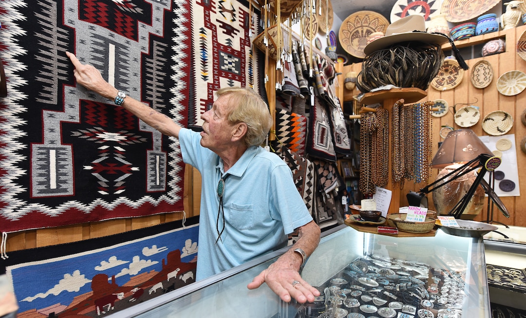 (Francisco Kjolseth  |  The Salt Lake Tribune)  Dave Dunn, owner of TP Gallery, an institution on Main Street for over 44 years, talks about the intricate work on an authentic Native American tapestry as he welcomes patrons to his store on Wed. Aug. 21, 2019. The store is scheduled to close sometime before the end of the year.