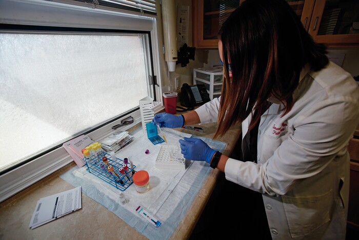(Luis Sánchez Saturno | Santa Fe New Mexican | The Associated Press) In this Wednesday, April 25, 2018 photo, Tamara Flys, director of research at Southwest Care in Santa Fe, N.M., prepares a patient's blood sample to be sent out for testing. The HIV/AIDS clinic has been at the forefront of AIDS research over the past 30 years.