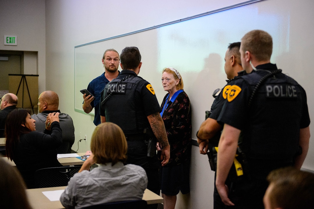 (Trent Nelson  |  The Salt Lake Tribune)  
Activist Ethan Peterson argues with police who are removing him from a meeting of an inland port satellite working group (which was quickly canceled), held at a police precinct in Salt Lake City on Wednesday, Aug. 14, 2019. At center is Jill Merritt.