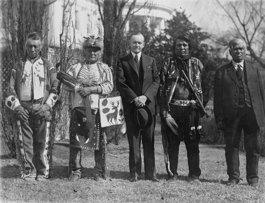 (Library of Congress via The New York Times) A photo provided by the Library of Congress shows President Calvin Coolidge with a Native delegation, possibly from the Plateau area in the Northwestern United States, near the South Lawn of the White House in 1925, the year after the passage of the Snyder Act, which extended U.S. citizenship to all Native people. The 19th Amendment did not bring the right to vote to all Native women, but two experts in a conversation said it did usher in the possibility of change.