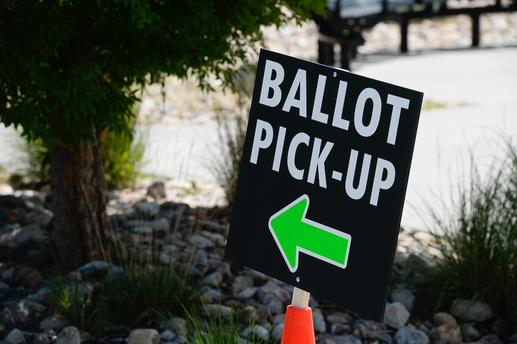 (Francisco Kjolseth  |  Tribune file photo) People line up for one of twelve drive-up voting assistance centers in Salt Lake County, Utah, at the Northwest Recreation Center on Tuesday, June 30, 2020, as workers go to cars to help people get ballots to replace lost ones or help unaffiliated voters register Republican to be able to vote in the primary. Davis County had just one drive-up voting locations on election day.