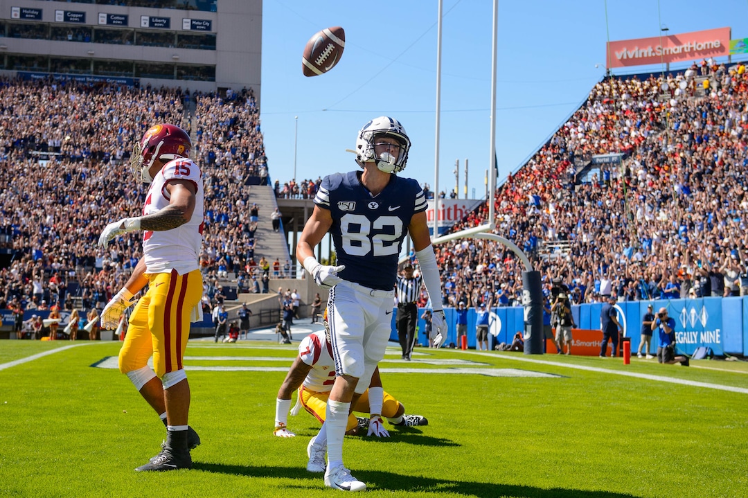 (Trent Nelson  |  The Salt Lake Tribune)  Brigham Young Cougars wide receiver Dax Milne (82) scores a touchdown as BYU hosts USC, NCAA football in Provo on Saturday Sept. 14, 2019.