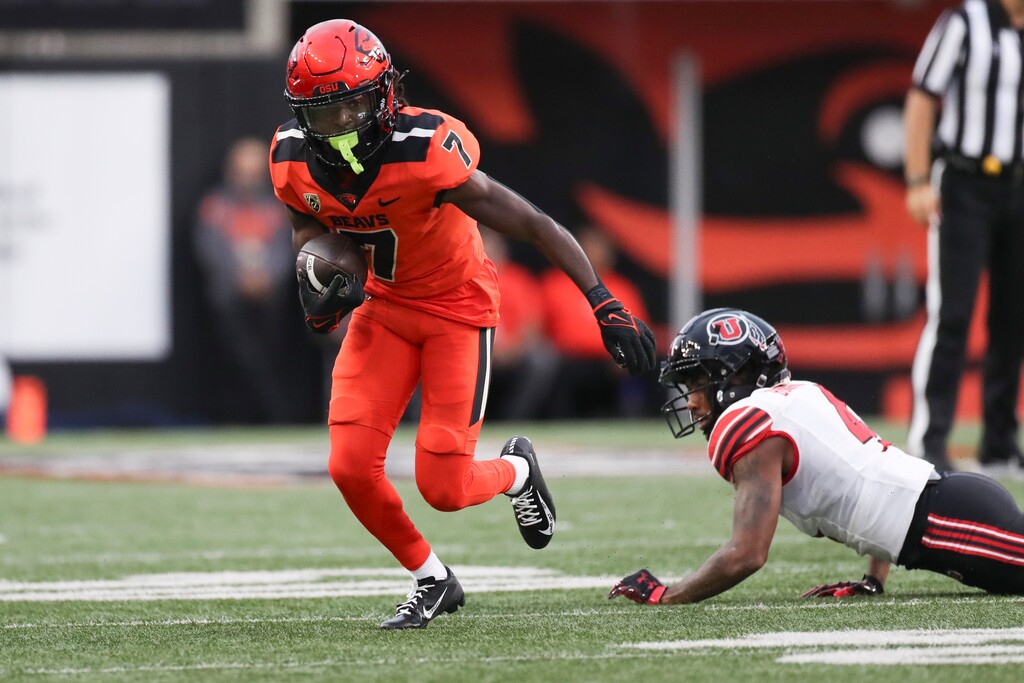(Amanda Loman | AP) Oregon State wide receiver Silas Bolden (7) dodges Utah cornerback JaTravis Broughton (4) during the first half Friday in Corvallis, Ore.