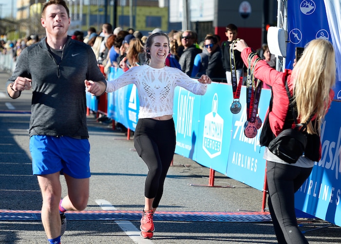 (Scott Sommerdorf | The Salt Lake Tribune)An excited runner crosses the finish line to claim her medal in the Salt Lake City half marathon, Saturday, April 21, 2018.