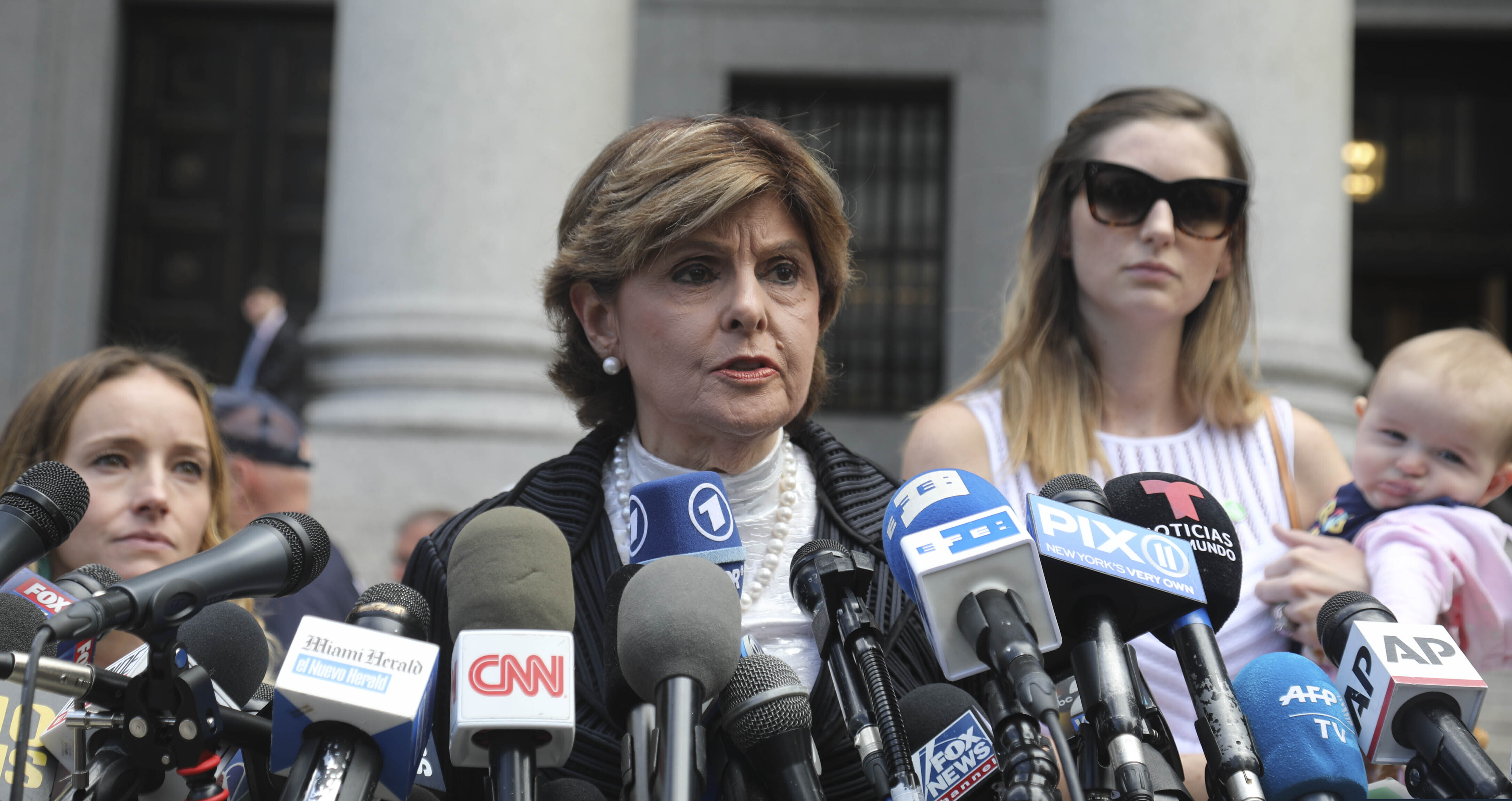 (Bebeto Matthews | AP Photo) Attorney Gloria Allred, center, flanked by two of her clients, speaks during a news conference after leaving a Manhattan court where sexual victims, on invitation of a judge, addressed a hearing after the accused Jeffrey Epstein killed himself before facing sex trafficking charges, Tuesday Aug. 27, 2019, in New York.