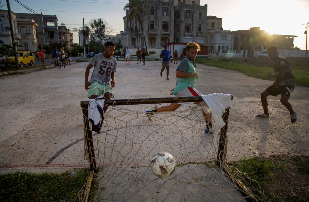 Youths plays soccer in the Vedado neighborhood of Havana, Cuba, Aug. 18, 2019. Six decades ago, the U.S. implemented an embargo against Cuba with the objective of stifling the economy and bringing down the communist government, however, according to many experts it instead harmed the population while generating resilience. (AP Photo/Ismael Francisco)
