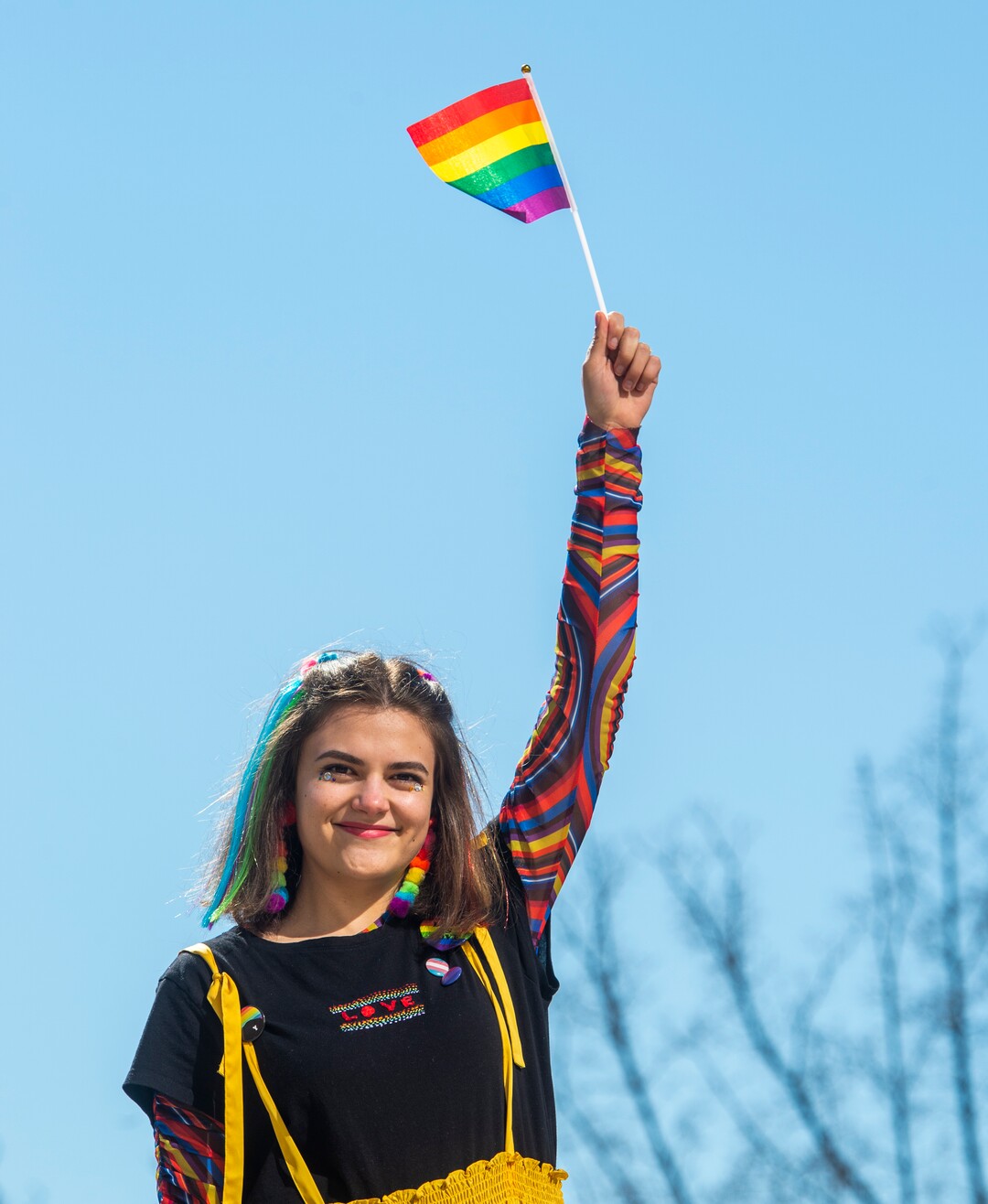 (Rick Egan  |  The Salt Lake Tribune)   Madeline Taylor waves a flag during a Rainbow Day gathering on the BYU Campus, Wednesday, Feb. 26, 2020.