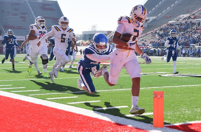 (Francisco Kjolseth  |  The Salt Lake Tribune)  Orem's Buju Tuisavura runs in a touchdown past Dixie  in the 4A high school championship game at Rice Eccles Stadium in Salt Lake City, Friday, Nov. 16, 2018.