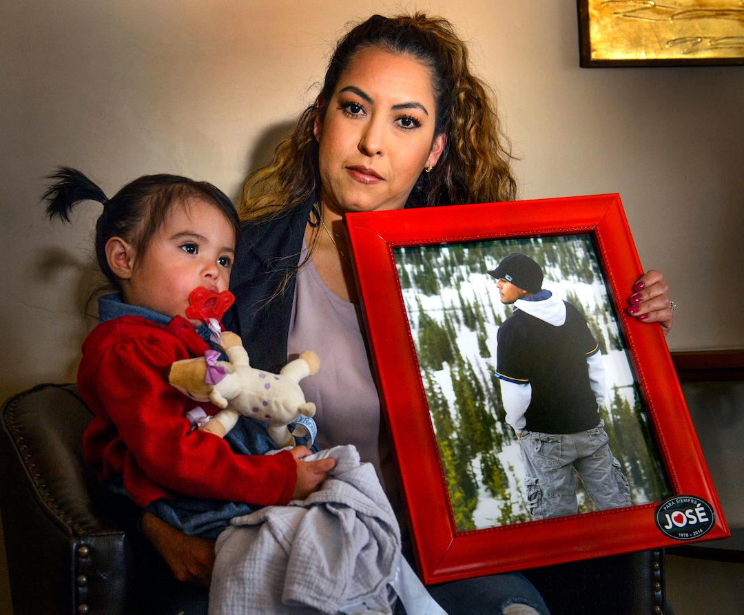 (Steve Griffin  |  The Salt Lake Tribune)  Griselle Trujillo holds her 19-month-old daughter Luna Faith Fernandez and a photograph of her husband Jose Fernandez who was killed by a friend with a handgun. She was photographed in Heber, Utah Tuesday April 24, 2018.  
