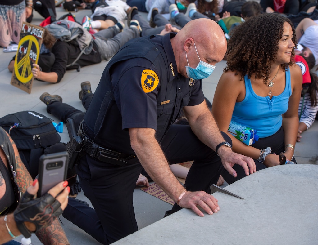 (Rick Egan  |  The Salt Lake Tribune)     Police Chief Mike Brown  kneels down in silence along with the crowd for 9 minutes in memory of George Floyd, during a demonstration at the Public Safety Building, Wednesday, June 3, 2020.