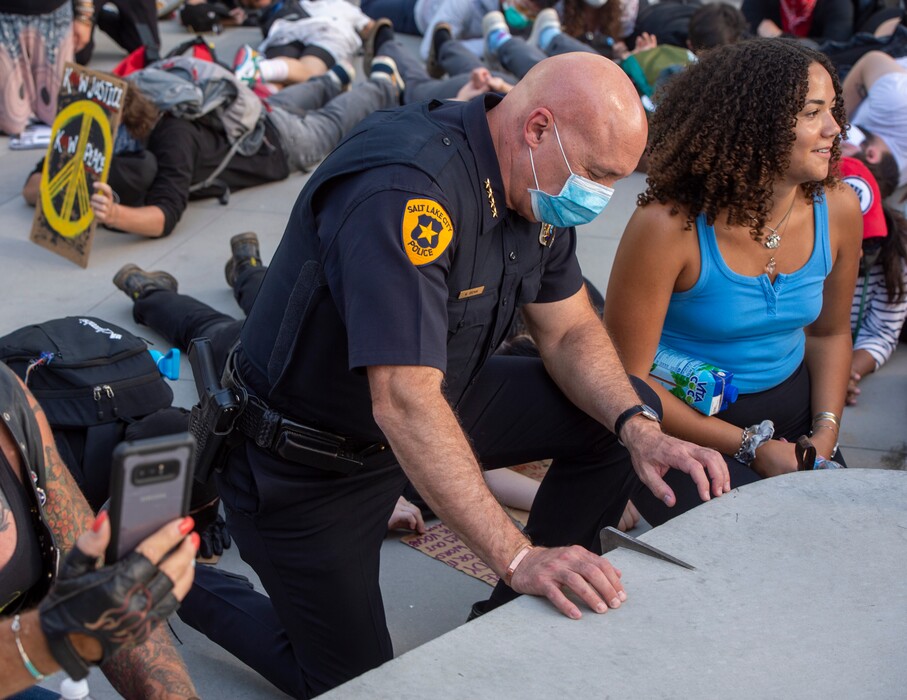 (Rick Egan  |  The Salt Lake Tribune)     Police Chief Mike Brown  kneels down in silence along with the crowd for 9 minutes in memory of George Floyd, during a demonstration at the Public Safety Building, Wednesday, June 3, 2020.