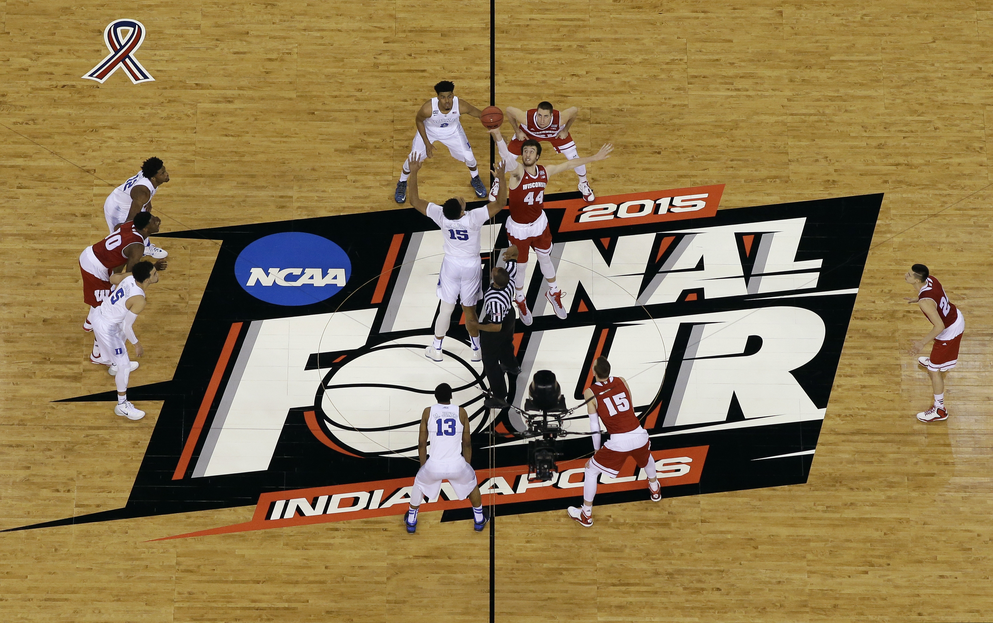 (David J. Phillip | AP) Duke and Wisconsin tip off at the NCAA tournament championship game in Indianapolis, Monday, April 6, 2015.