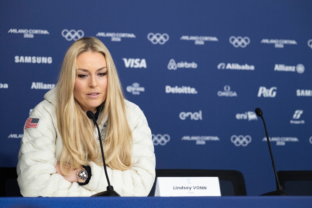 (James Hill | The New York Times) Lindsey Vonn, a downhill skier for the United States, speaks at a news conference where she announced she intended to compete despite a torn ACL during the 2026 Milan Cortina Winter Olympics in Cortina d’Apezzo, Italy, Feb. 3, 2026.