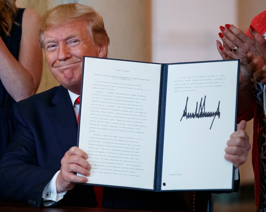 President Donald Trump holds up an executive order he just signed on improving price and quality transparency in healthcare at the White House in Washington, Monday, June 24, 2019. (AP Photo/Carolyn Kaster)