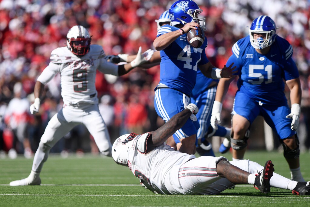 (Annie Rice | AP) BYU quarterback Bear Bachmeier (47) is tackled by Texas Tech defensive lineman Lee Hunter (2) during the second half of a game Saturday, Nov. 8, 2025, in Lubbock, Texas.