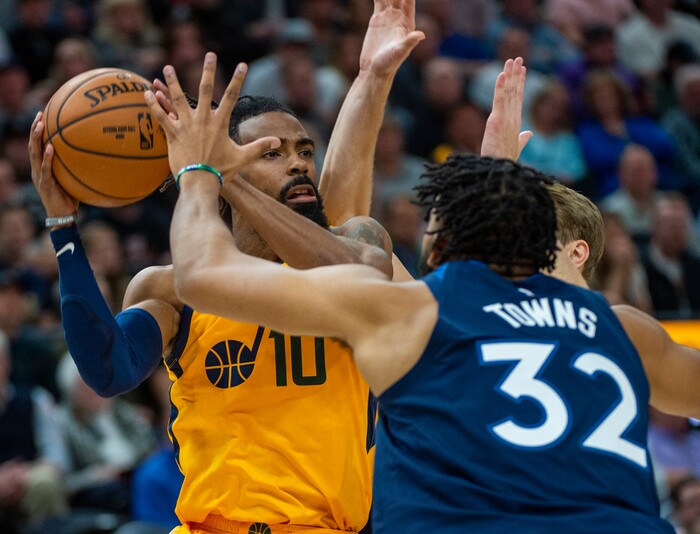 (Rick Egan  |  The Salt Lake Tribune)     Minnesota Timberwolves center Karl-Anthony Towns (32) puts the pressure on Utah Jazz guard Mike Conley (10), in NBA action between the Utah Jazz and the Minnesota Timberwolves in Salt Lake City, Monday, Nov. 18, 2019.