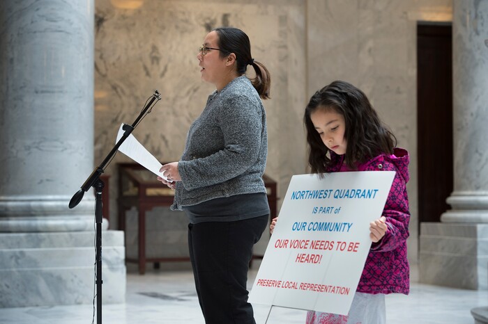 Scott Sommerdorf | The Salt Lake Tribune
Denni Cawley speaks as her daughter Erin holds a sign as Utahns concerned about environmental health consequences and community impact from creating a state controlled inland port authority in Salt Lake CityÕs northwest quadrant held a press conference in the capitol rotunda, Sunday, March 4, 2018.