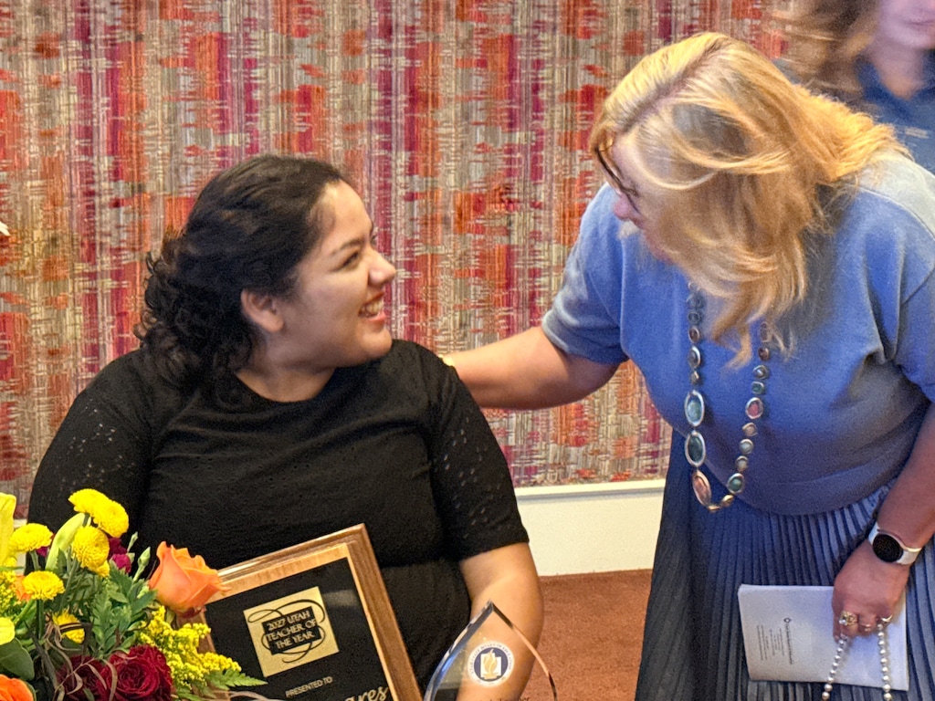 (Utah Education Association) Talia Casares, left, receives congratulations after being named 2027 Utah Teacher of the Year at an awards ceremony on Sept. 3, 2026. Casares, a sixth grade teacher at Moroni Elementary in Sanpete County, died Sept. 14, the North Sanpete School District reported.