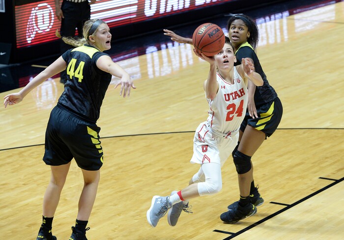 Scott Sommerdorf | The Salt Lake TribuneUtah Utes guard/forward Tilar Clark (24) splits the Oregon defense on this first half drive to the basket. Oregon defeated Utah 84-68, Sunday, January 28, 2018.