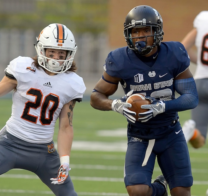 Utah State cornerback Jalen Davis (13) intercepts a pass intended for Idaho State wide receiver Michael Dean (20), returning it for a touchdown, during an NCAA football game Thursday, Sept. 7, 2017, in Logan, Utah. (Eli Lucero/Herald Journal via AP)