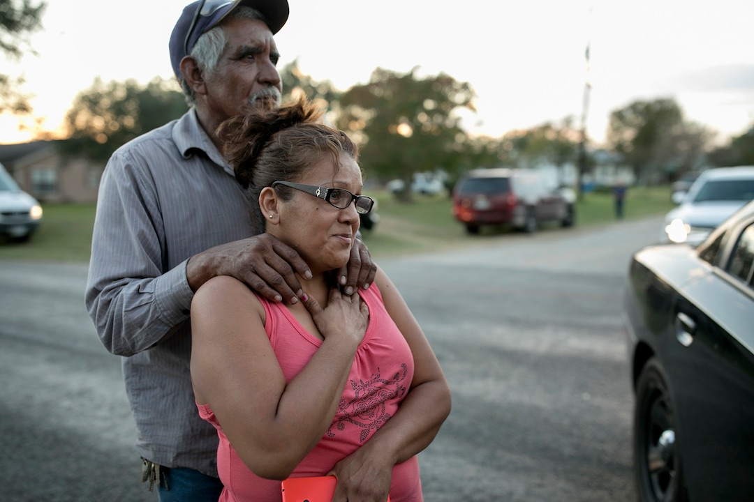 (Jay Janner  |  Austin American-Statesman via AP)  Enrique and Gabby Garcia watch investigators at the scene of a mass shooting at the First Baptist Church in Sutherland Springs, Texas, on Sunday Nov. 5, 2017. A man opened fire inside of the church in the small South Texas community on Sunday, killing more than 20 people.