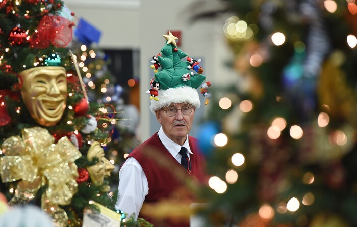 (Francisco Kjolseth  |  The Salt Lake Tribune)  John Watkins of Clearfield gets into the spirit of the Festival of Trees at the South Towne Exposition Center in Sandy on Friday, Dec. 1, 2017. "It's on my head and it's for sale," exclaimed Watkins as he walked the isles with his granddaughter Emma Bargar, 11. The annual festival which runs through Saturday raises money for children at Primary Children's Hospital.