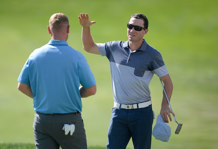 (Scott Sommerdorf | The Salt Lake Tribune)
Eddie Olson congratulates Patrick Fishburn, left, who won the Utah Open golf tournament played at the Riverside Country Club, Sunday, August 27, 2017. Fishburn crushed the field, with a 26 under score, nine strokes ahead of second place finisher Zahkai Brown at -17.