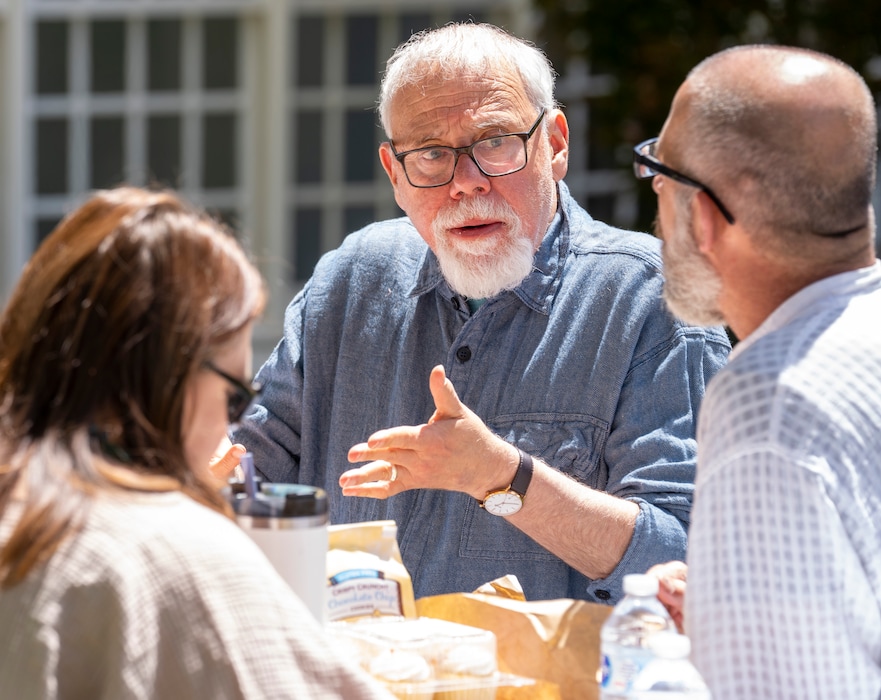 (Rick Egan | The Salt Lake Tribune) The Rev. Tom Goldsmith shares a laugh Tuesday, May 11, 2021, during his final staff meeting outside on the lawn at the First Unitarian Church of Salt Lake City. Goldsmith is retiring after 34 years at the head of the Unitarian Church.