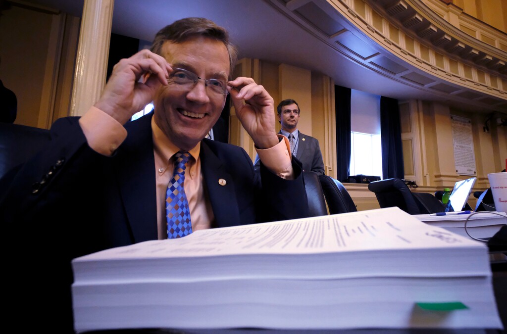 (Bob Brown/Richmond Times-Dispatch via AP) Del. S. Chris Jones, R-Suffolk, chairman of the House Appropriations committee, smiles just before the new Virginia budget passed the House of Delegates, with Medicaid expansion as a provision inside the State Capitol n Richmond, Va., Wednesday, May 30, 2018.