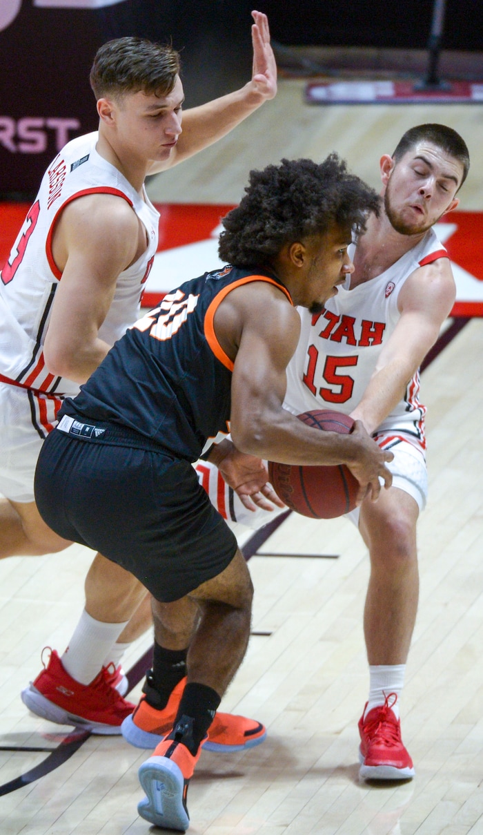 (Leah Hogsten  |  The Salt Lake Tribune) Utah Utes guard Pelle Larsson (3) and Utah Utes guard Rylan Jones (15) pressure Idaho State Bengals guard Robert Ford III (20) during their NCAA basketball matchup Tuesday, Dec. 8, 2020 at the Jon M. Huntsman Center.