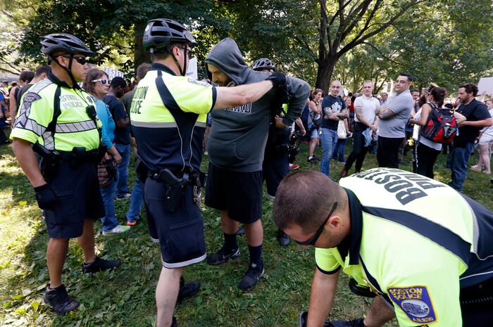 State and city police inspect people arriving for a "Free Speech" rally on Boston Common, Saturday, Aug. 19, 2017, in Boston. The permit for the rally came with severe restrictions, including a ban on backpacks, sticks and anything that could be used as a weapon. (AP Photo/Michael Dwyer)