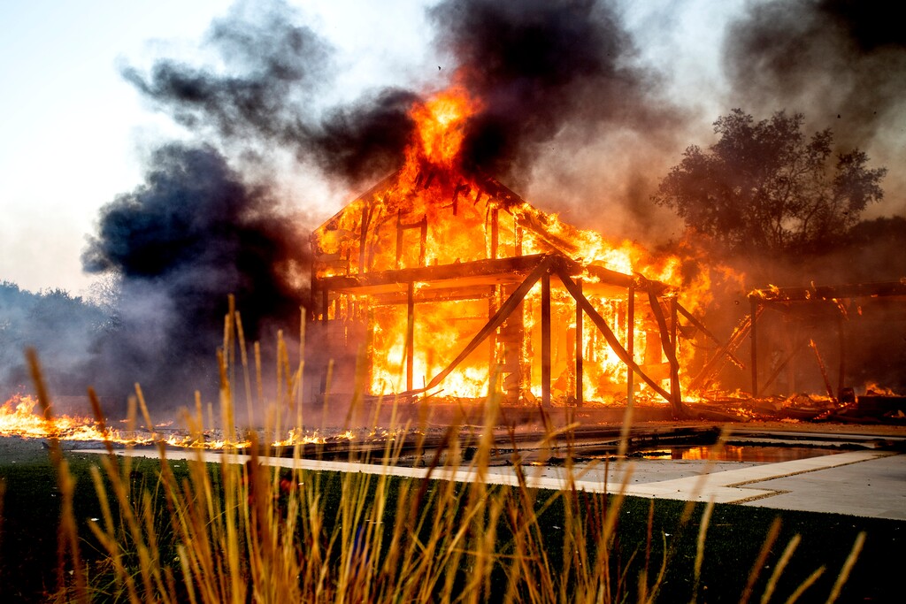 (Noah Berger | The Associated Press) Flames from the Kincade Fire consume a home in Healdsburg, Calif., on Sunday, Oct 27, 2019.