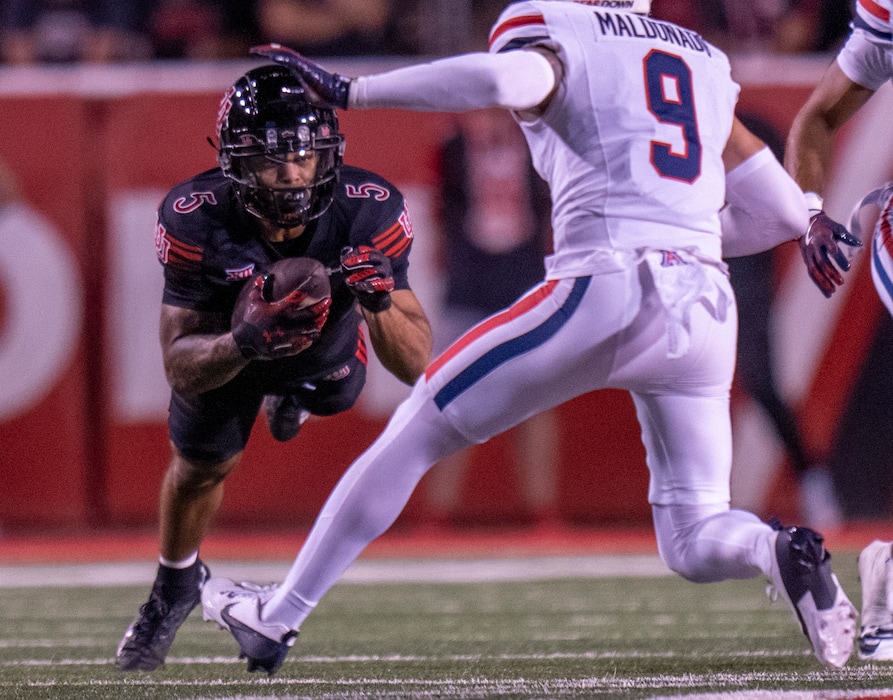 (Rick Egan | The Salt Lake Tribune)  Utah Utes wide receiver Mycah Pittman (5) grabs a pass, as Arizona Wildcats defensive back Gunner Maldonado (9) defends, in Big-12 action between the Utah Utes and the Arizona Wildcats at Rice-Eccles Stadium, on Saturday, Sept. 28, 2024.