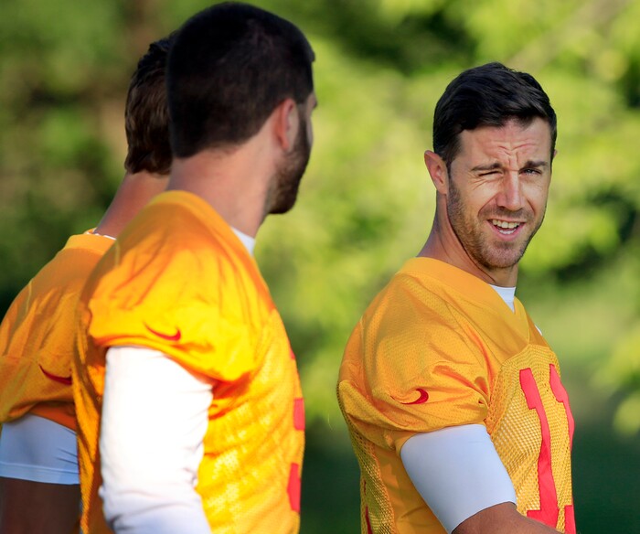 Kansas City Chiefs quarterback Alex Smith (11), right, talks with teammates while walking to the practice field during NFL football training camp in St. Joseph, Mo., Tuesday, July 25, 2017. (AP Photo/Orlin Wagner)
