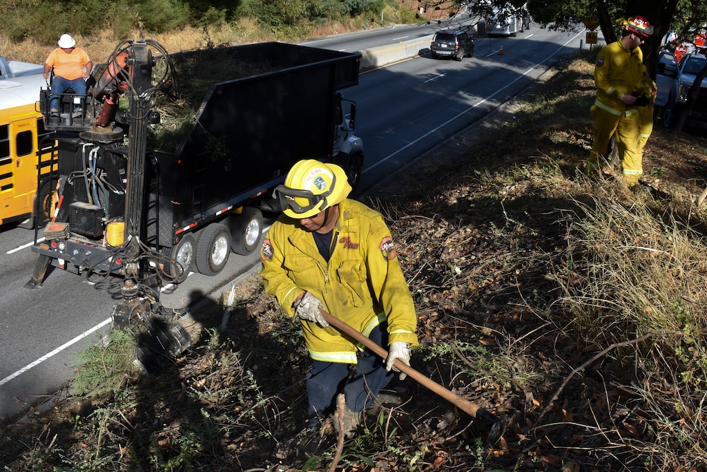(Matthew Brown | AP) A fire prevention crew removes vegetation along California's Route 17 on Wednesday, Nov. 20, 2019, near Redwood Estates, Calif. Authorities are rushing to clear vegetation in high-risk communities after fires killed 149 people and destroyed almost 25,000 homes in the state over the past three years.