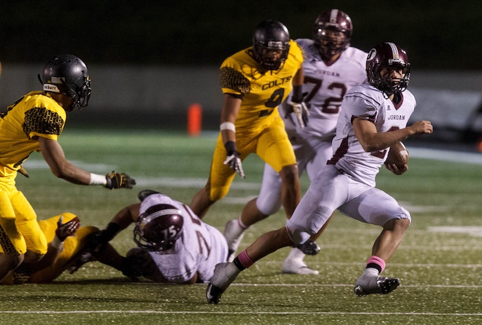(Trent Nelson  |  The Salt Lake Tribune)  Jordan quarterback Austin Kafentzis runs the ball as Cottonwood hosts Jordan High School football, Friday October 5, 2012 at Rice-Eccles Stadium in Salt Lake City, Utah.