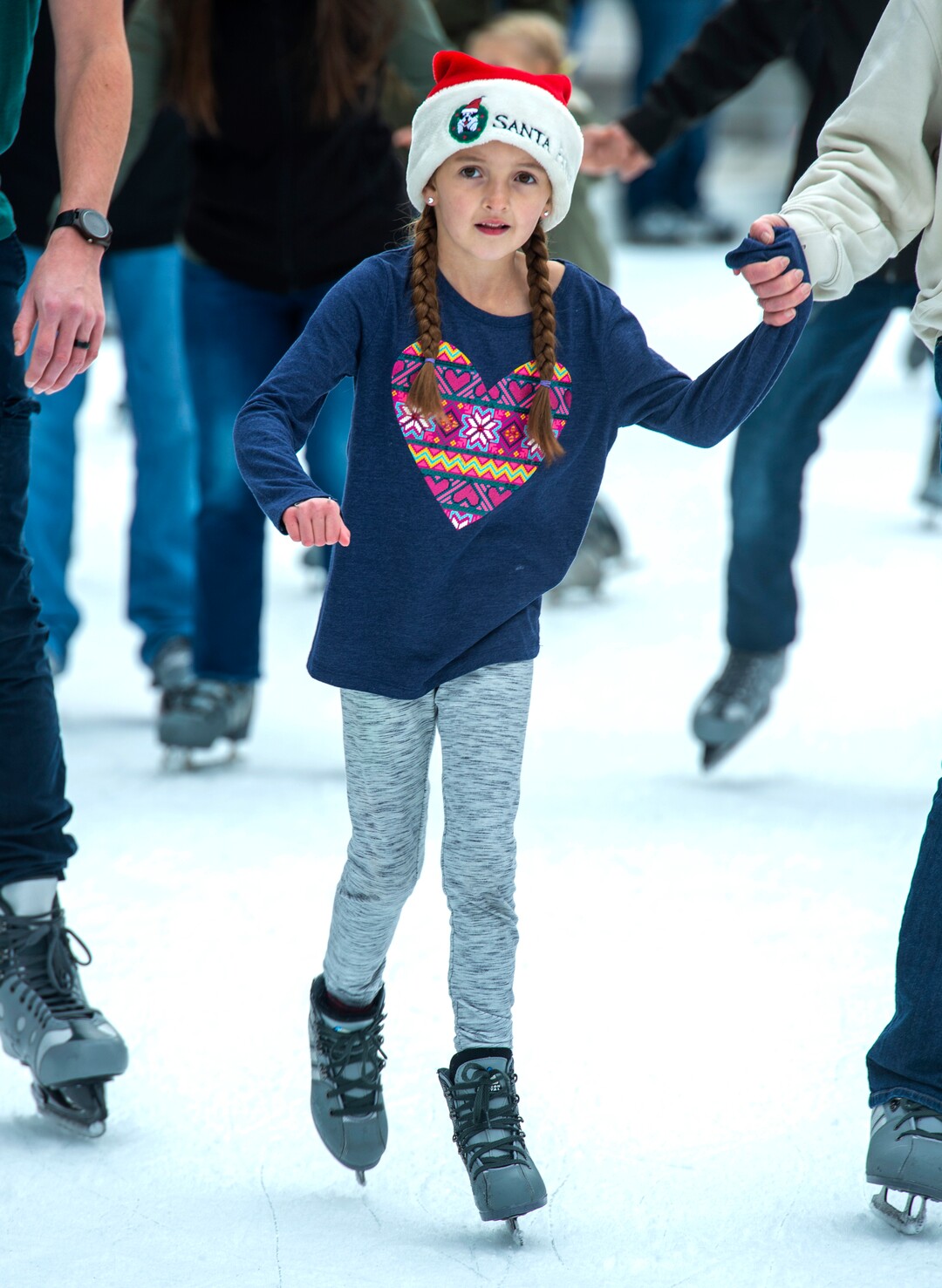(Rick Egan  |  The Salt Lake Tribune)  Leili Sloan, 7, wears her Santa Paws hat as she ice skates at the Gallivan Center, on Christmas Eve, Tuesday, Dec. 24, 2019.