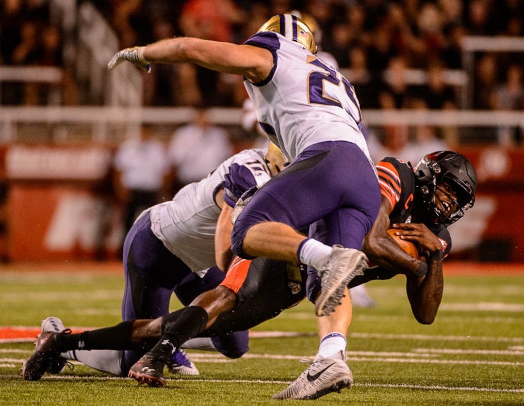 (Trent Nelson | The Salt Lake Tribune)  Utah Utes quarterback Tyler Huntley (1) is tackled as the University of Utah hosts Washington at Rice-Eccles Stadium in Salt Lake City, Saturday Sept. 15, 2018.