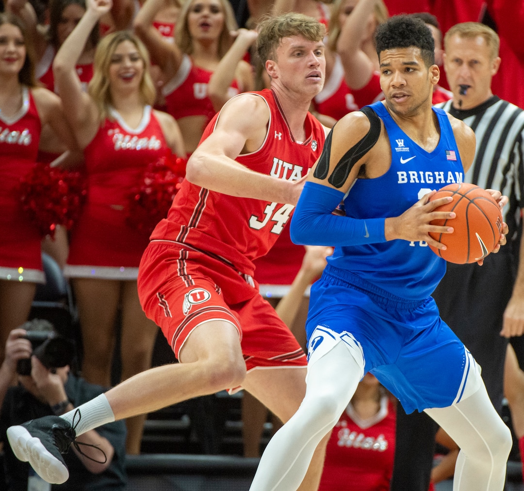 (Rick Egan  |  The Salt Lake Tribune)   Brigham Young Cougars forward Yoeli Childs (23) works the ball, as Utah Utes center Jayce Johnson (34) defends, in basketball action in the Beehive Classic, between against the Brigham Young Cougars and Utah Utes, at the Vivint Smart Home Arena, Saturday December 8, 2018.