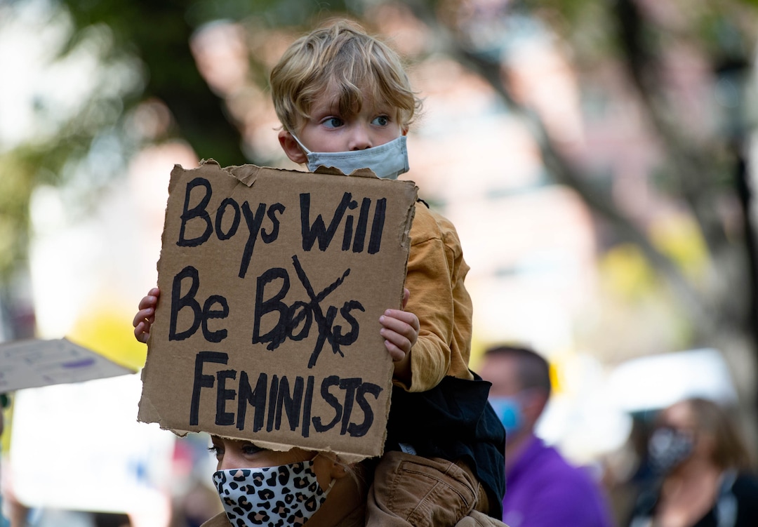 (Francisco Kjolseth  |  The Salt Lake Tribune) Natalie Burt carries her son Britain, 4, as they join other demonstrators gathered in Salt Lake City, uniting with Women’s March rallies happening in Washington D.C. and around the country on Saturday, Oct. 17, 2020, to signal their opposition to President Donald Trump and his agenda, including his push to fill the seat of late Supreme Court Justice Ruth Bader Ginsburg before election day.