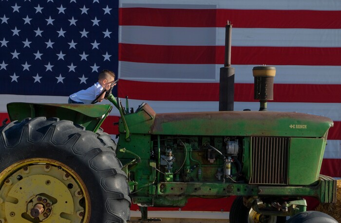 (Leah Hogsten | The Salt Lake Tribune) Mateo Lopez, 2, shoves his face into the tractor steering wheel while making tractor sounds during the Baby Animal Festival and Tulip Field Festival at Cross E Ranch, April 23, 2021.The festival runs unlil May 8.