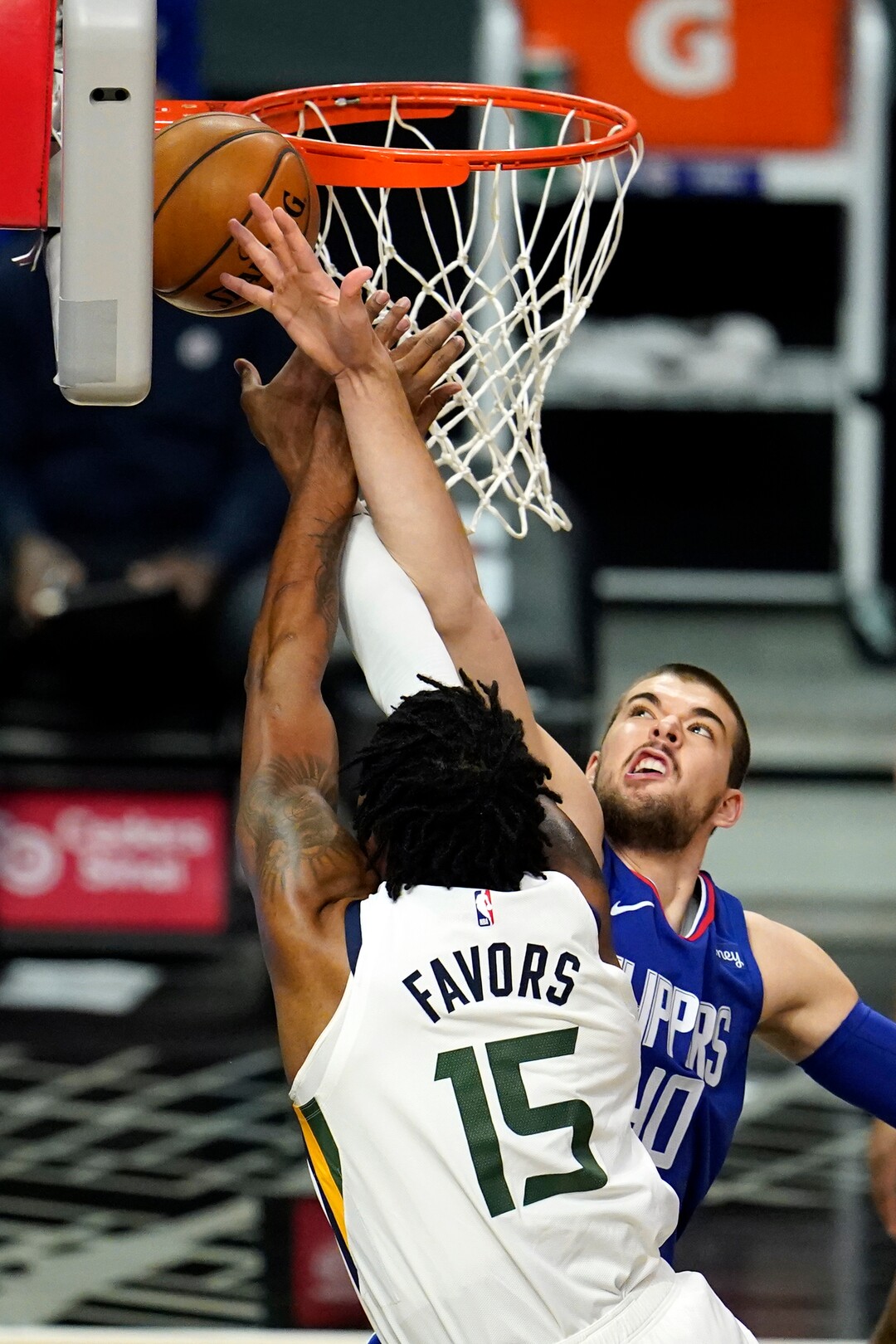 Los Angeles Clippers center Ivica Zubac, right, blocks a shot from Utah Jazz center Derrick Favors (15) during the first half of an NBA basketball game Wednesday, Feb. 17, 2021, in Los Angeles. (AP Photo/Marcio Jose Sanchez)
